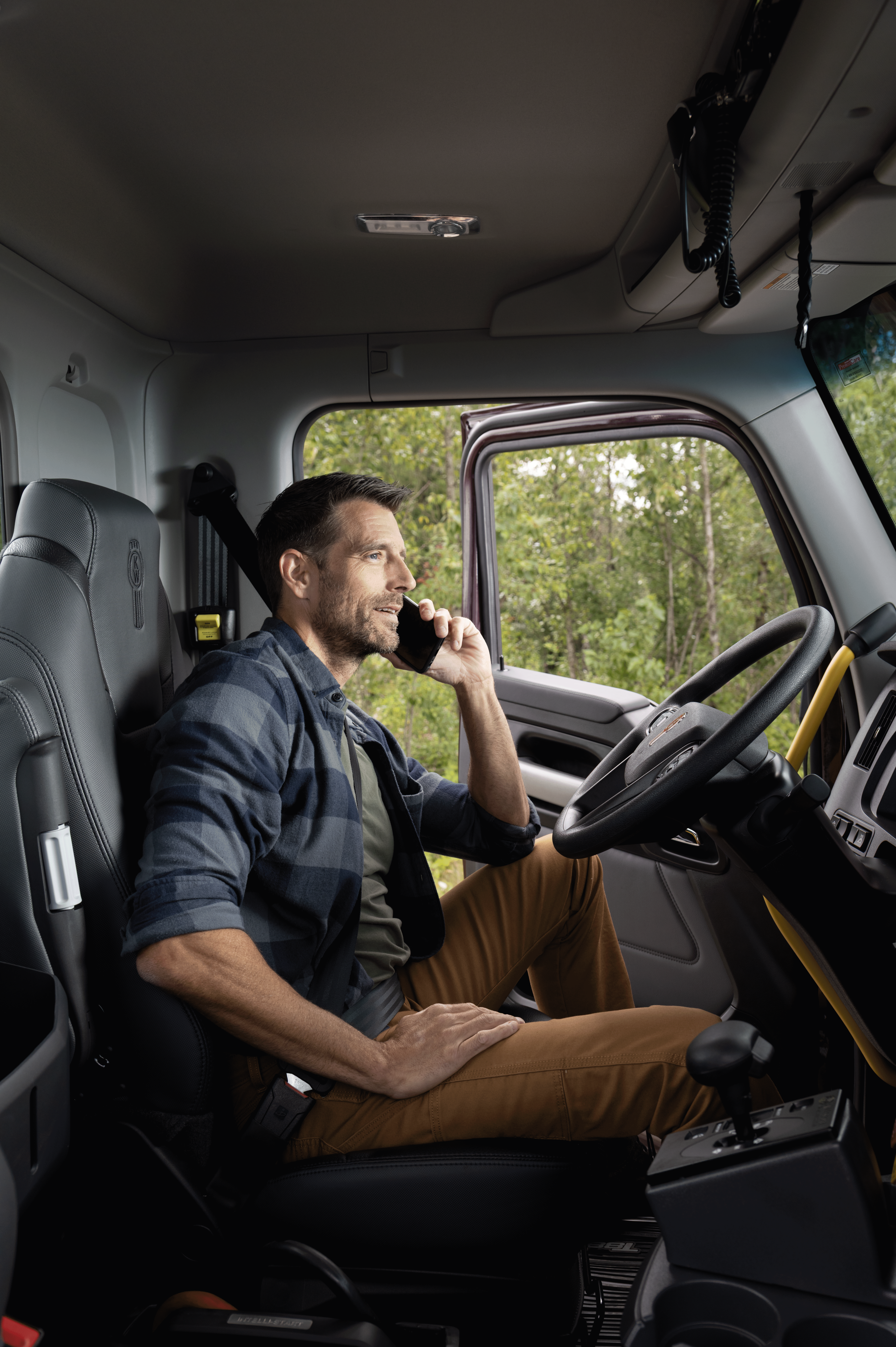 A Kenworth technician services a truck